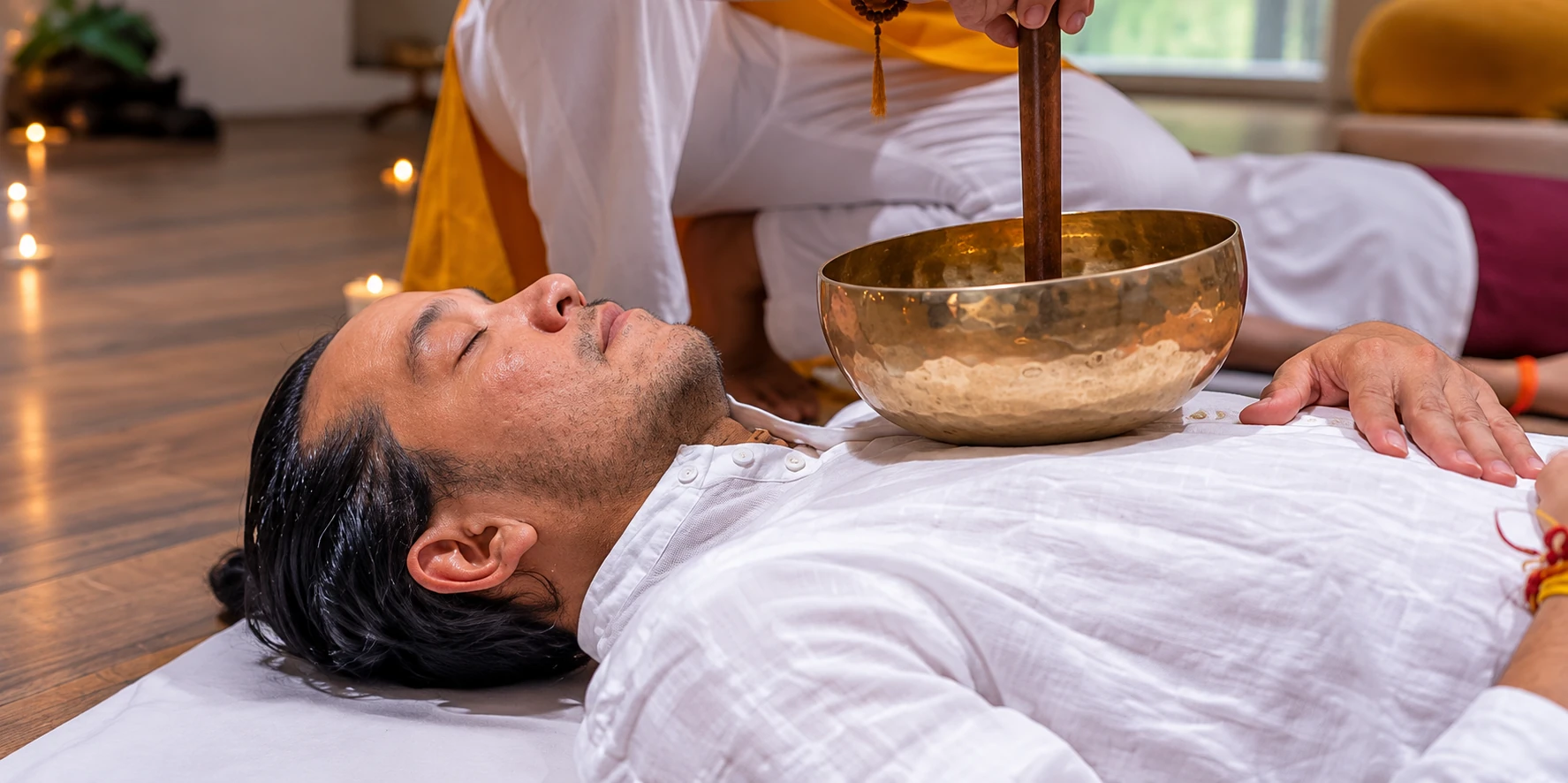 Therapist using a singing bowl on a client